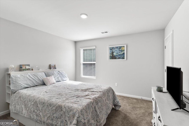 carpeted bedroom with visible vents and baseboards