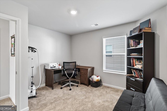 office with visible vents, light carpet, and baseboards