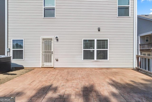 rear view of house with a patio area and central AC unit