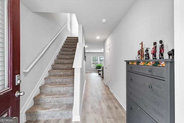 interior space with recessed lighting, wood finished floors, and baseboards