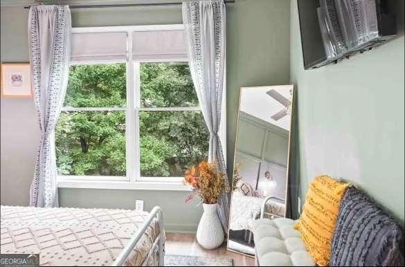 bedroom featuring hardwood / wood-style flooring and multiple windows