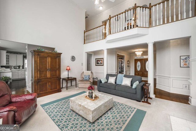 2290 Spencers Way, Stone Mountain, GA 30087 - carpeted living area with crown molding, a high ceiling, ceiling fan, and ornate columns