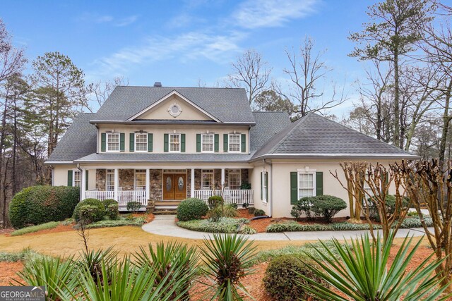 2290 Spencers Way, Stone Mountain, GA 30087 - view of front of house featuring stucco siding, roof with shingles, covered porch, and stone siding