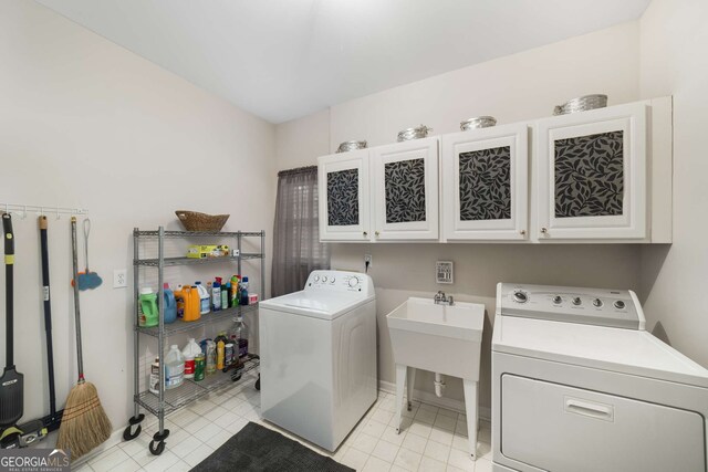 2290 Spencers Way, Stone Mountain, GA 30087 - clothes washing area featuring light tile patterned flooring, baseboards, cabinet space, and washing machine and dryer