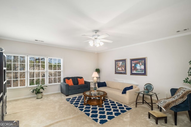 living room featuring ornamental molding, ceiling fan, and carpet