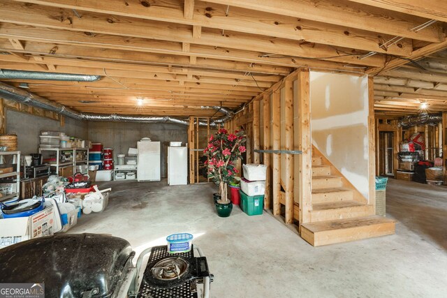 2290 Spencers Way, Stone Mountain, GA 30087 - unfinished basement featuring freestanding refrigerator and stairs