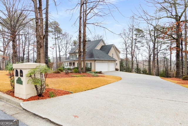 2290 Spencers Way, Stone Mountain, GA 30087 - view of side of home with a garage, stucco siding, driveway, and a yard