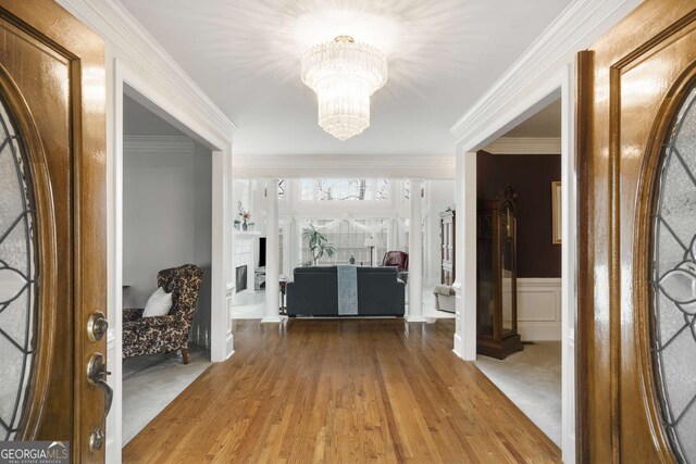 2290 Spencers Way, Stone Mountain, GA 30087 - foyer entrance featuring a chandelier, wood finished floors, a wainscoted wall, and crown molding