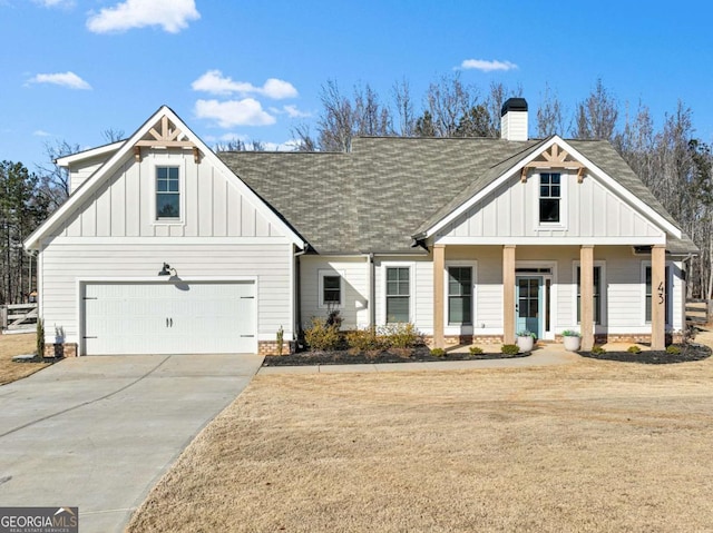 view of front of house with a garage, a porch, and a front lawn