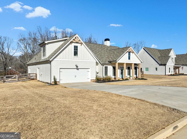 view of front of home featuring a garage, covered porch, and a front lawn