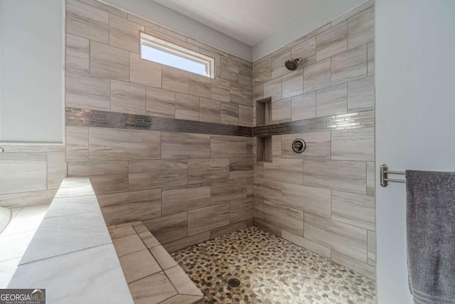 bathroom with a tile shower