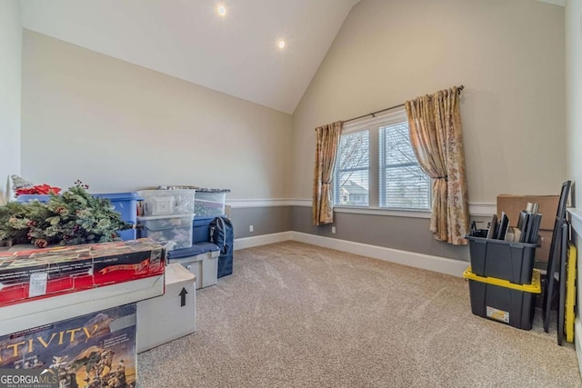 sitting room featuring carpet flooring and high vaulted ceiling