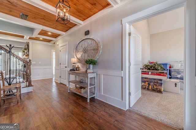 entrance foyer with coffered ceiling, wood ceiling, a chandelier, dark hardwood / wood-style flooring, and beam ceiling