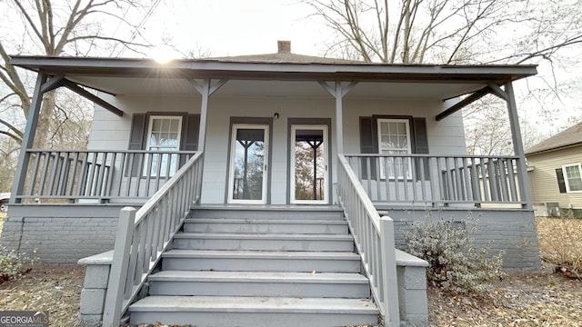 view of exterior entry with a porch