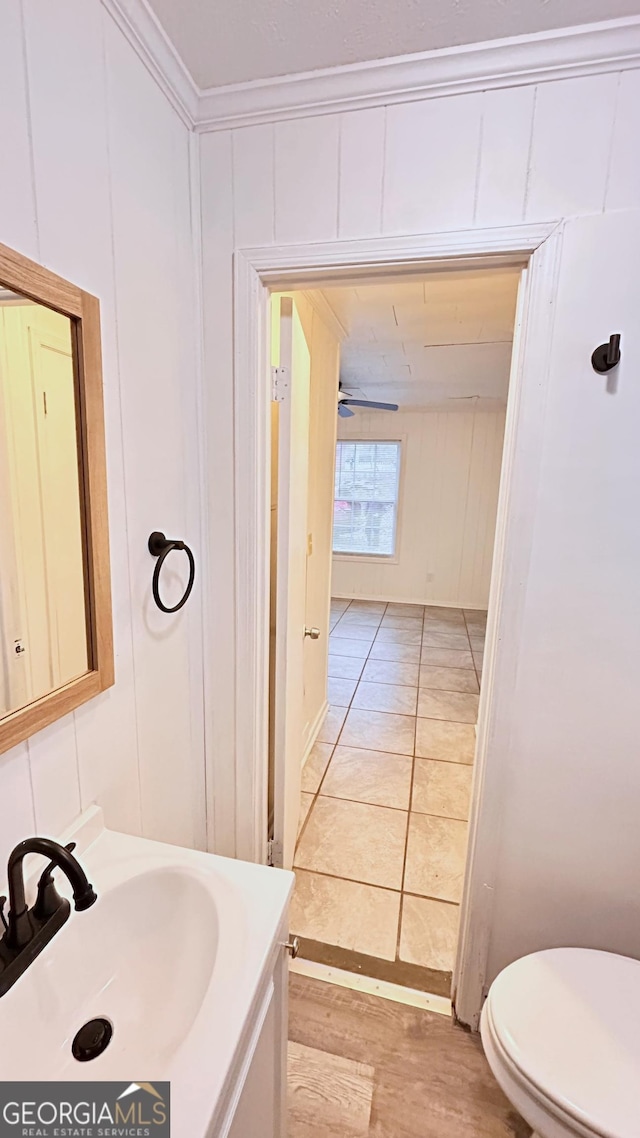 bathroom with ornamental molding, toilet, and vanity