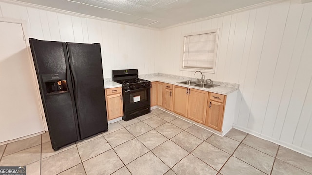 kitchen featuring light tile patterned flooring, light brown cabinetry, sink, ornamental molding, and black appliances