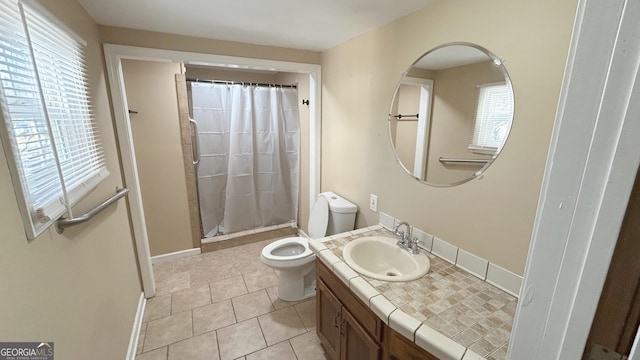 bathroom featuring tile patterned floors, vanity, toilet, and curtained shower