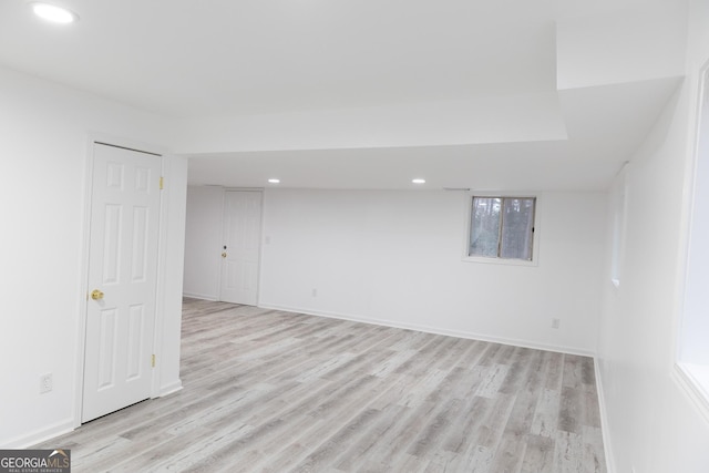 basement with light hardwood / wood-style floors