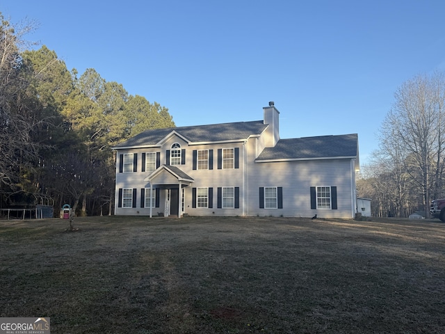 colonial inspired home featuring a front lawn