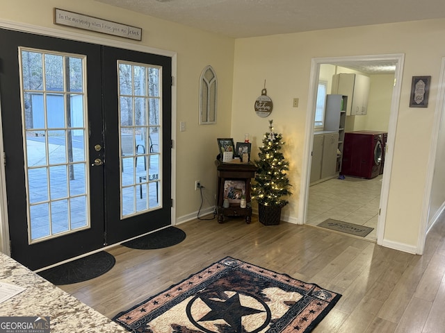 foyer with hardwood / wood-style floors, french doors, and a textured ceiling