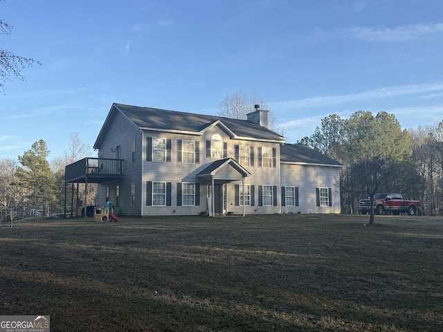 colonial inspired home with a deck and a front yard