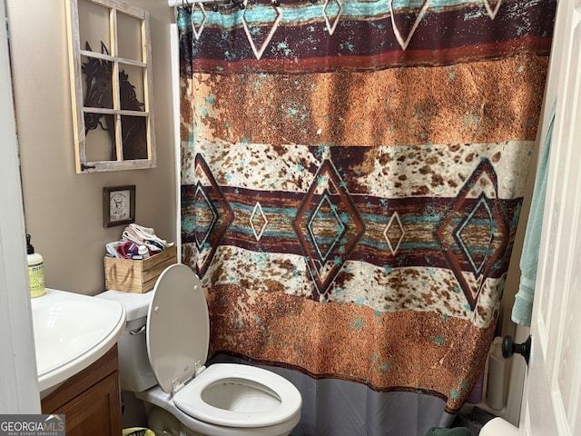 bathroom with vanity, curtained shower, and toilet