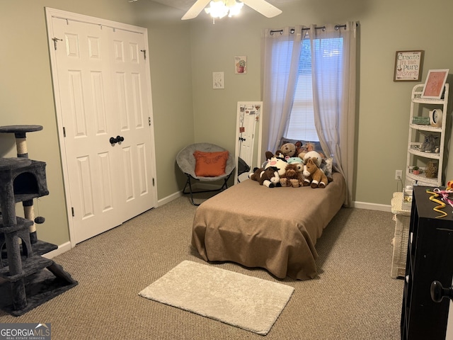 bedroom featuring carpet, ceiling fan, and a closet