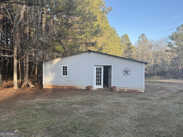 rear view of property featuring a lawn