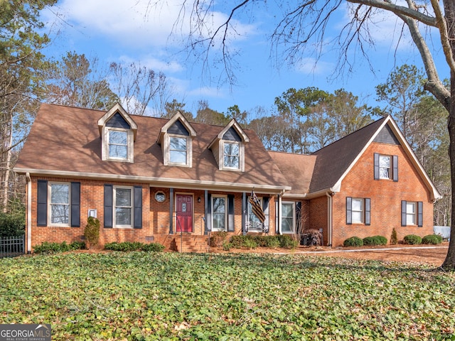 new england style home with a front lawn