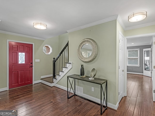 foyer entrance with ornamental molding and dark hardwood / wood-style flooring