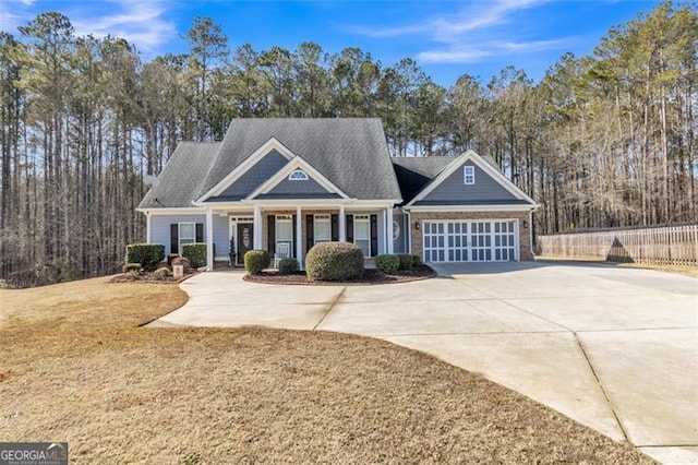 craftsman-style home featuring a garage and a front yard