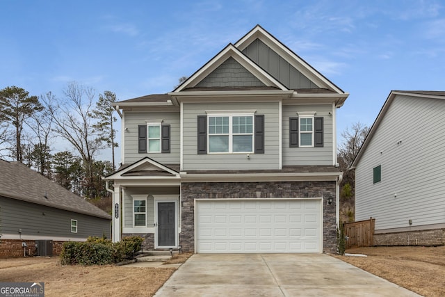 craftsman house with central AC unit and a garage