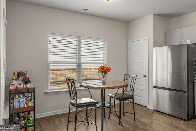 dining space featuring dark hardwood / wood-style flooring