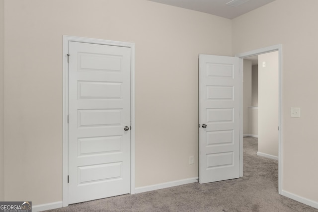 unfurnished bedroom featuring light carpet