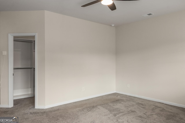 empty room featuring ceiling fan and carpet flooring