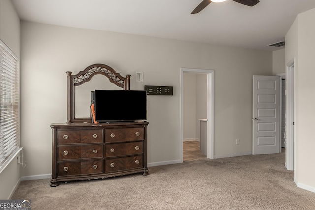 bedroom featuring light colored carpet and ceiling fan