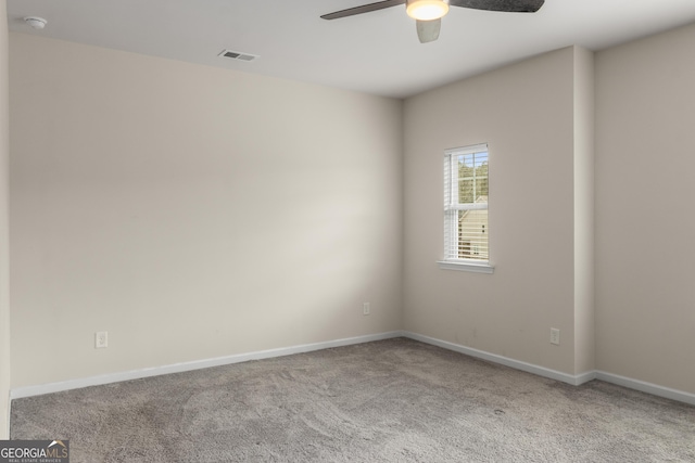 empty room featuring light carpet and ceiling fan