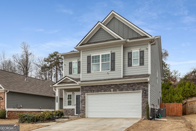 craftsman inspired home with cooling unit and a garage