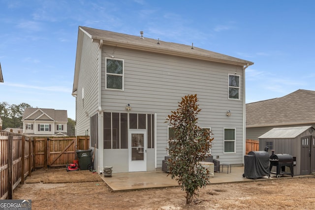 back of property featuring a patio and a storage unit