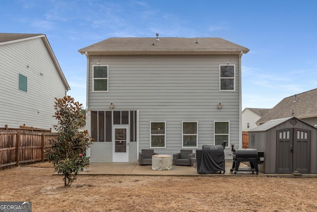 rear view of house with a storage unit and a patio area