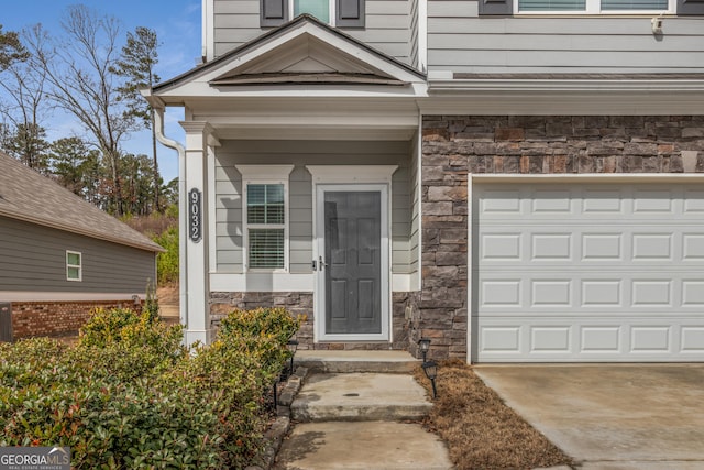 view of exterior entry with a garage