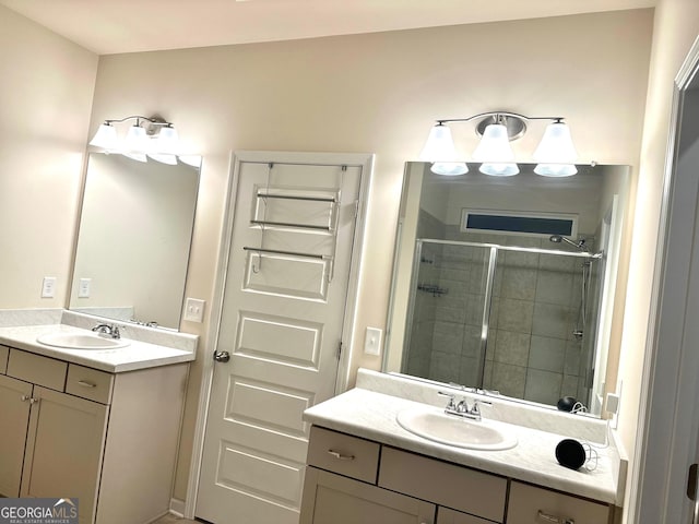 bathroom with vanity and a shower with door