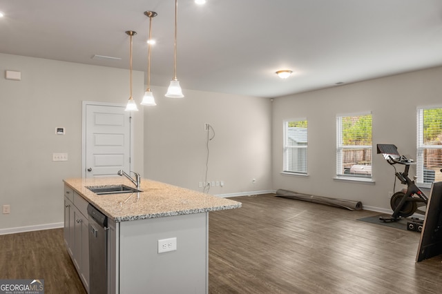 kitchen with sink, dishwasher, light stone countertops, a center island with sink, and decorative light fixtures