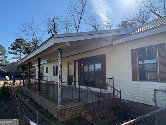 back of property featuring a porch