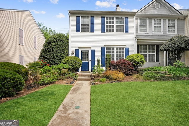 3742 Berkeley Xing, Duluth, GA 30096 - view of front facade with a chimney and a front lawn