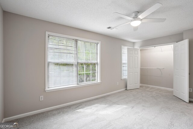 3742 Berkeley Xing, Duluth, GA 30096 - unfurnished bedroom with a closet, baseboards, a textured ceiling, carpet flooring, and ceiling fan