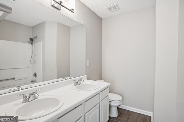3742 Berkeley Xing, Duluth, GA 30096 - full bath featuring wood finished floors, visible vents, toilet, and a sink