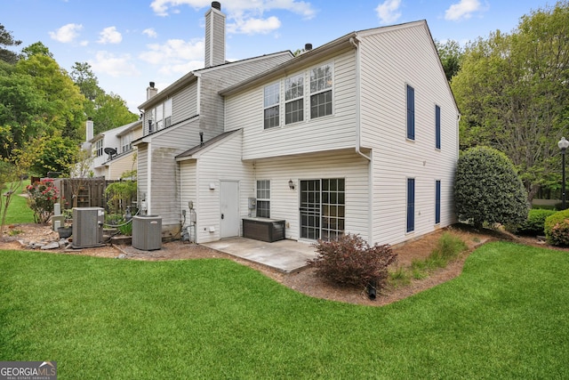 3742 Berkeley Xing, Duluth, GA 30096 - rear view of property featuring a chimney, a yard, and central AC