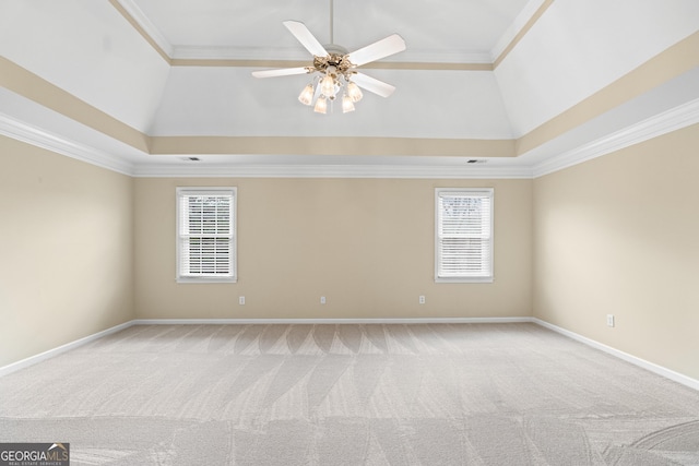 carpeted spare room with ceiling fan, crown molding, and a healthy amount of sunlight