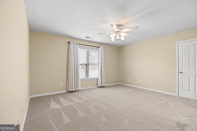 carpeted empty room featuring ceiling fan